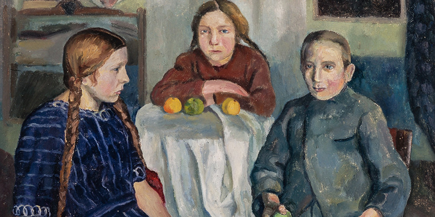 Three kids around a table.
